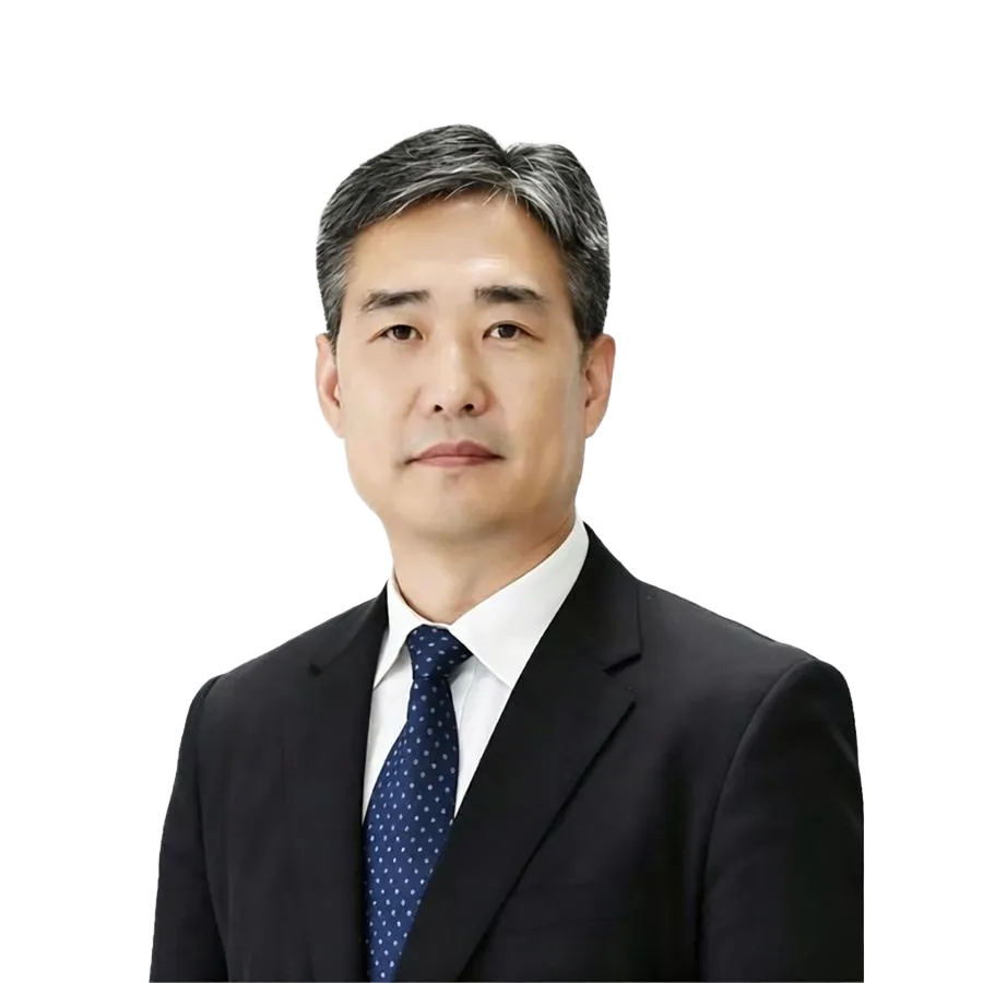 Middle-aged East Asian man with graying hair in a dark suit and patterned tie.